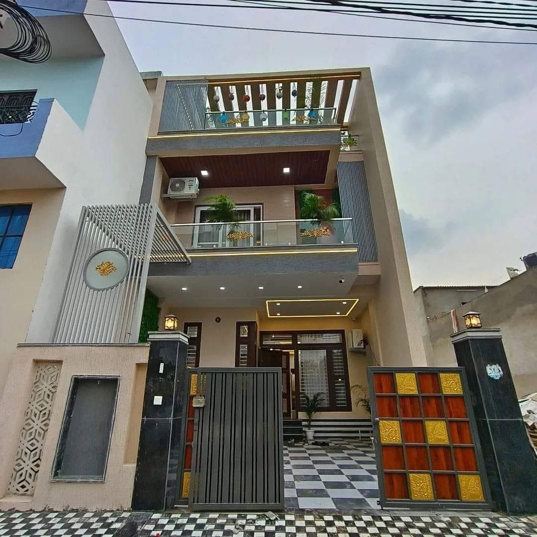 Contemporary Bangalore home with sculpted facade, custom gates, and warm exterior lighting